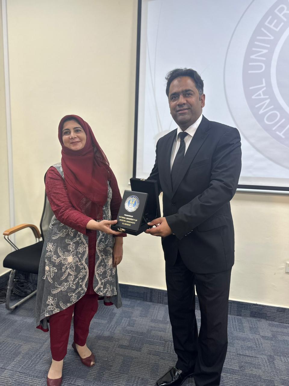 Receiving shield from HOD Mass Communication department NUML